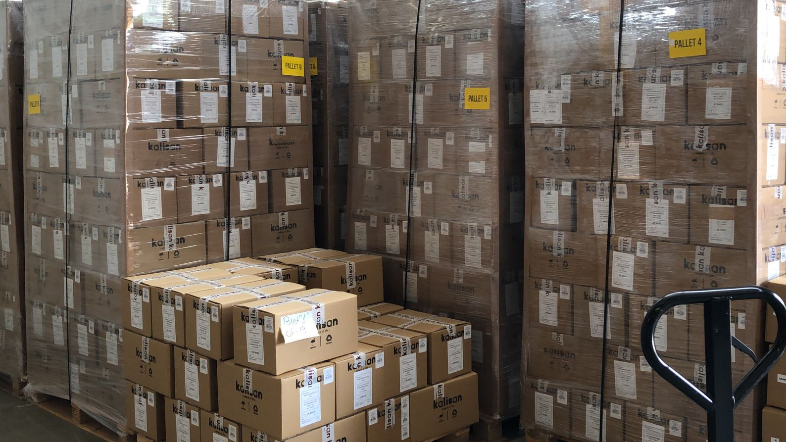 Stacks of cardboard boxes on pallets in a warehouse setting